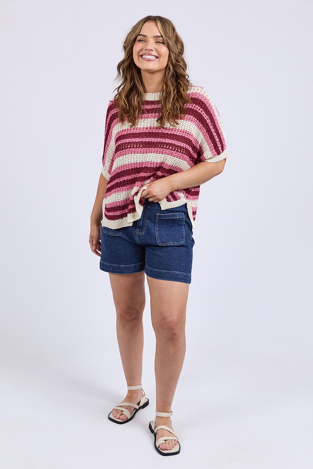 A model wearing the Striped Knit Top in colour Chateauros, from the front, showing the whole outfit