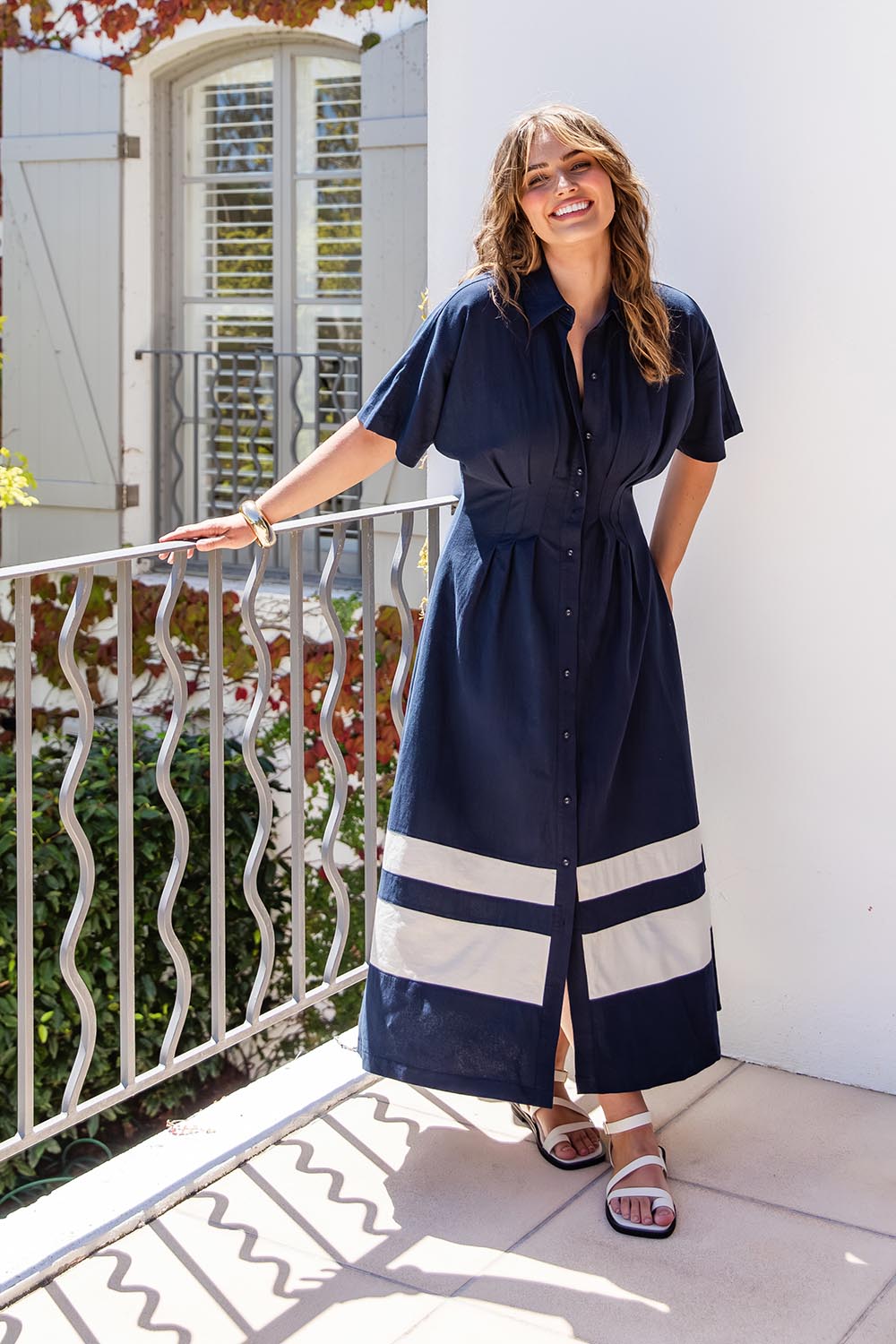 A model wearing the Scarlett Cotton Blend Midi Dress in colour Navystripe (Blue), from the front, showing the whole outfit