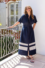 A model wearing the Scarlett Cotton Blend Midi Dress in colour Navystripe (Blue), from the front, showing the whole outfit