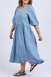 A model wearing the Sawyer Chambray Dress in colour Midblue (Blue), from the front, cropped image