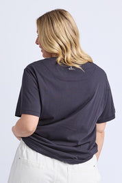 A model wearing the Azalea Cotton Tee in colour Navyazalea, from the back
