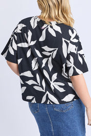 A model wearing the Mimosa Cotton Tee in colour Blackprint (Black), from the back