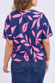 A model wearing the Mimosa Cotton Tee in colour Bluedepths, from the back