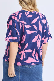 A model wearing the Mimosa Cotton Tee in colour Bluedepths, from the back