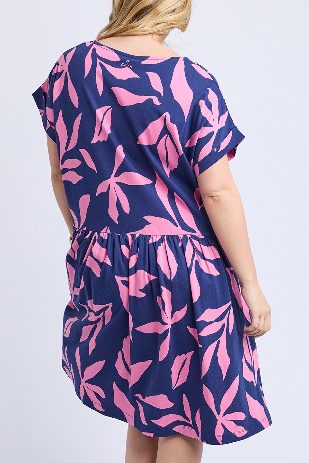 A model wearing the Mimosa Cotton Dress in colour Bluedepths, from the back