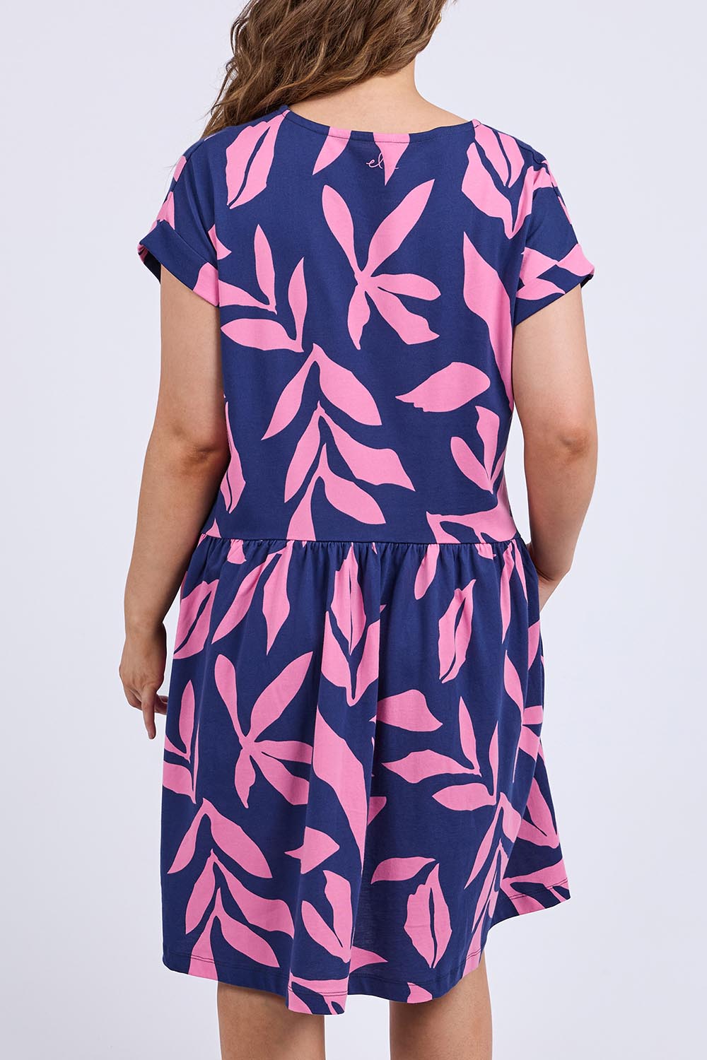 A model wearing the Mimosa Cotton Dress in colour Bluedepths, from the back