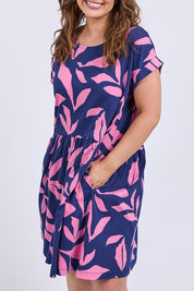 A model wearing the Mimosa Cotton Dress in colour Bluedepths, from the front, cropped image