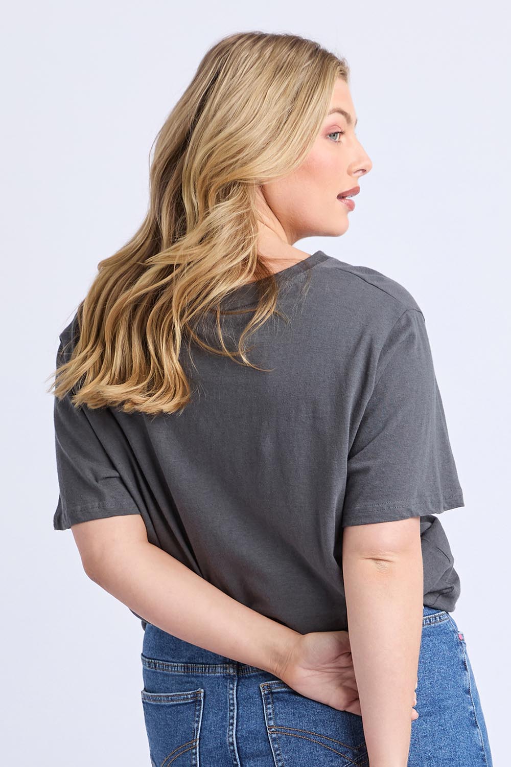 A model wearing the Fiore Cotton Linen Tee in colour Charcoal (Grey), from the back