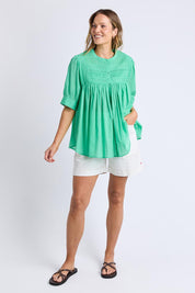 A model wearing the Monty Cotton Short Sleeve Shirt in colour Gumdrop (Green), from the front, showing the whole outfit