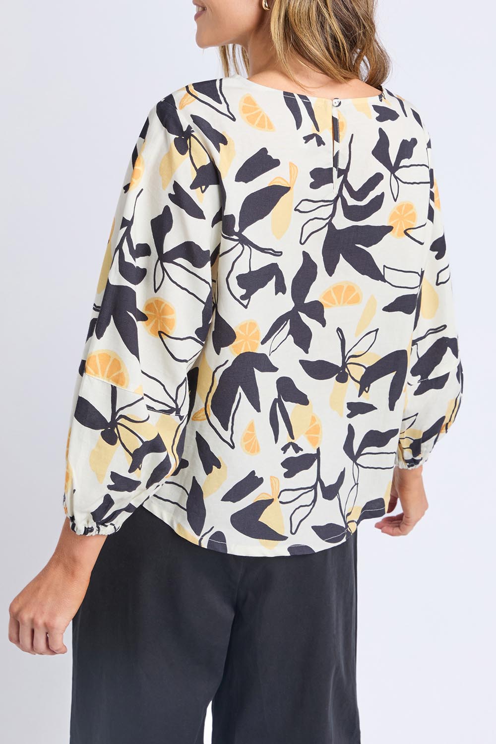 A model wearing the Limone Lyocell Linen Top in colour Limone, from the back