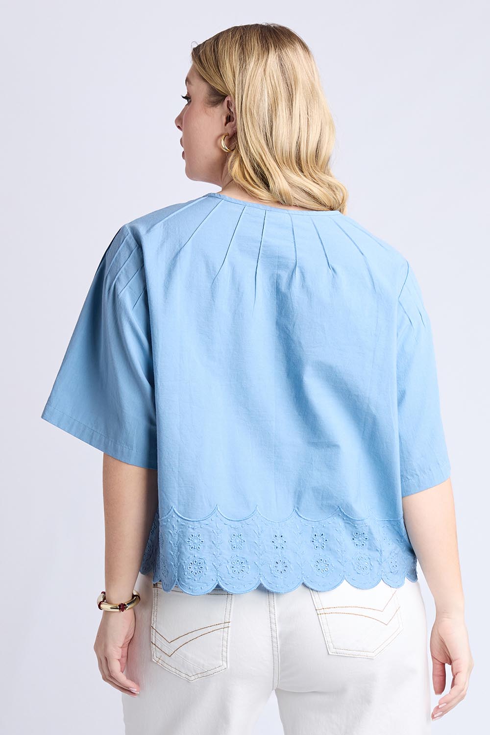 A model wearing the Brody Top in colour Blueshadow (Blue), from the back