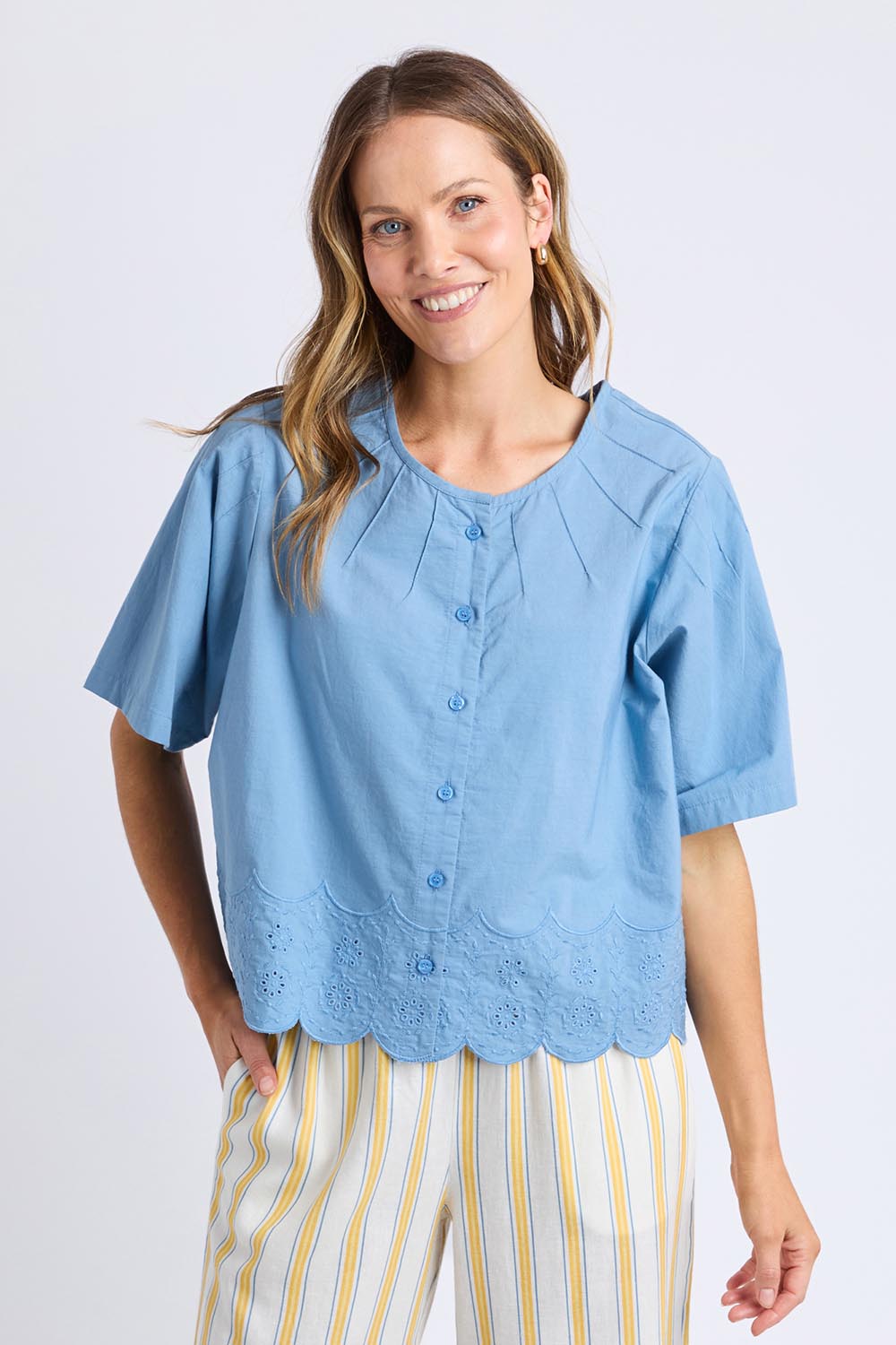 A model wearing the Brody Top in colour Blueshadow (Blue), from the front, cropped image