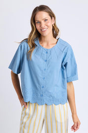 A model wearing the Brody Top in colour Blueshadow (Blue), from the front, cropped image