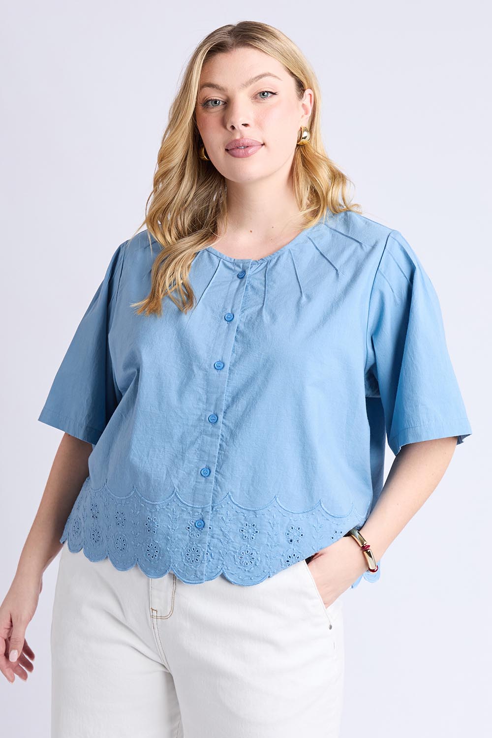 A model wearing the Brody Top in colour Blueshadow (Blue), from the front, cropped image