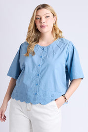 A model wearing the Brody Top in colour Blueshadow (Blue), from the front, cropped image