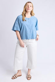 A model wearing the Brody Top in colour Blueshadow (Blue), from the front, showing the whole outfit