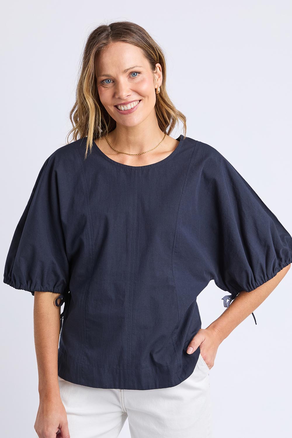 A model wearing the Marie Cotton Top in colour Navy (Blue), from the front, cropped image