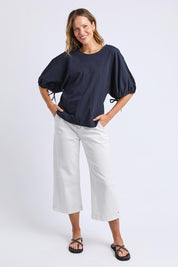 A model wearing the Marie Cotton Top in colour Navy (Blue), from the front, showing the whole outfit