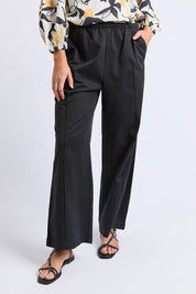 A model wearing the Lucinda Lyocell Cotton Pant in colour Black (Black), from the front, cropped image