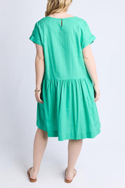 A model wearing the Sunset Hour Linen Blend Dress in colour Gumdrop (Green), from the back
