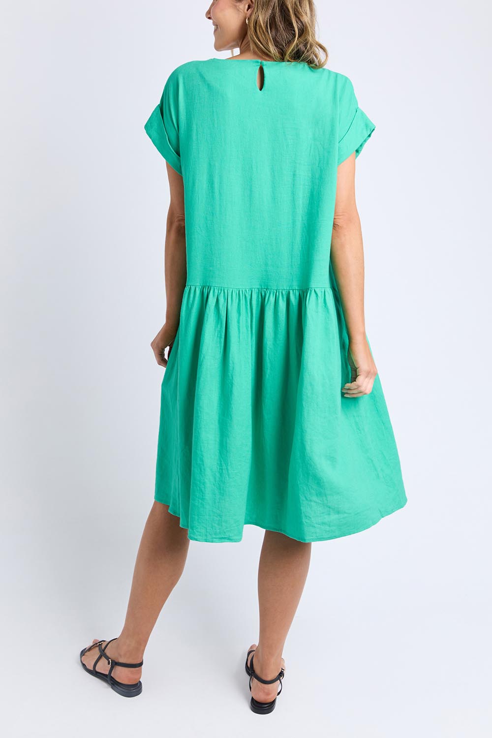 A model wearing the Sunset Hour Linen Blend Dress in colour Gumdrop (Green), from the back