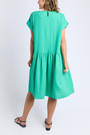 A model wearing the Sunset Hour Linen Blend Dress in colour Gumdrop (Green), from the back