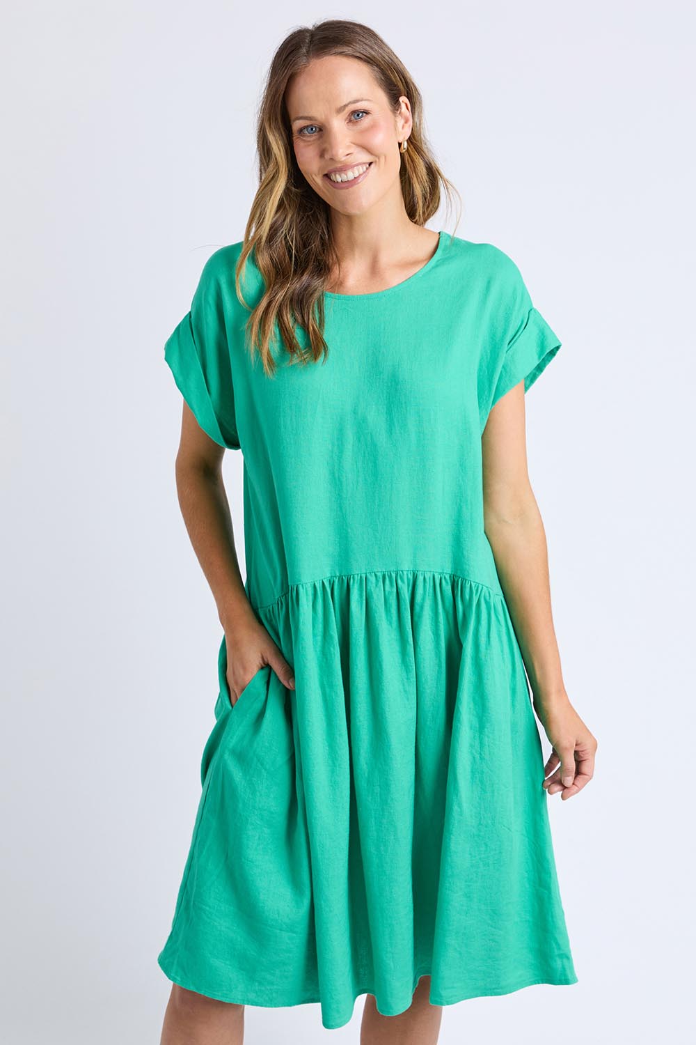 A model wearing the Sunset Hour Linen Blend Dress in colour Gumdrop (Green), from the front, cropped image