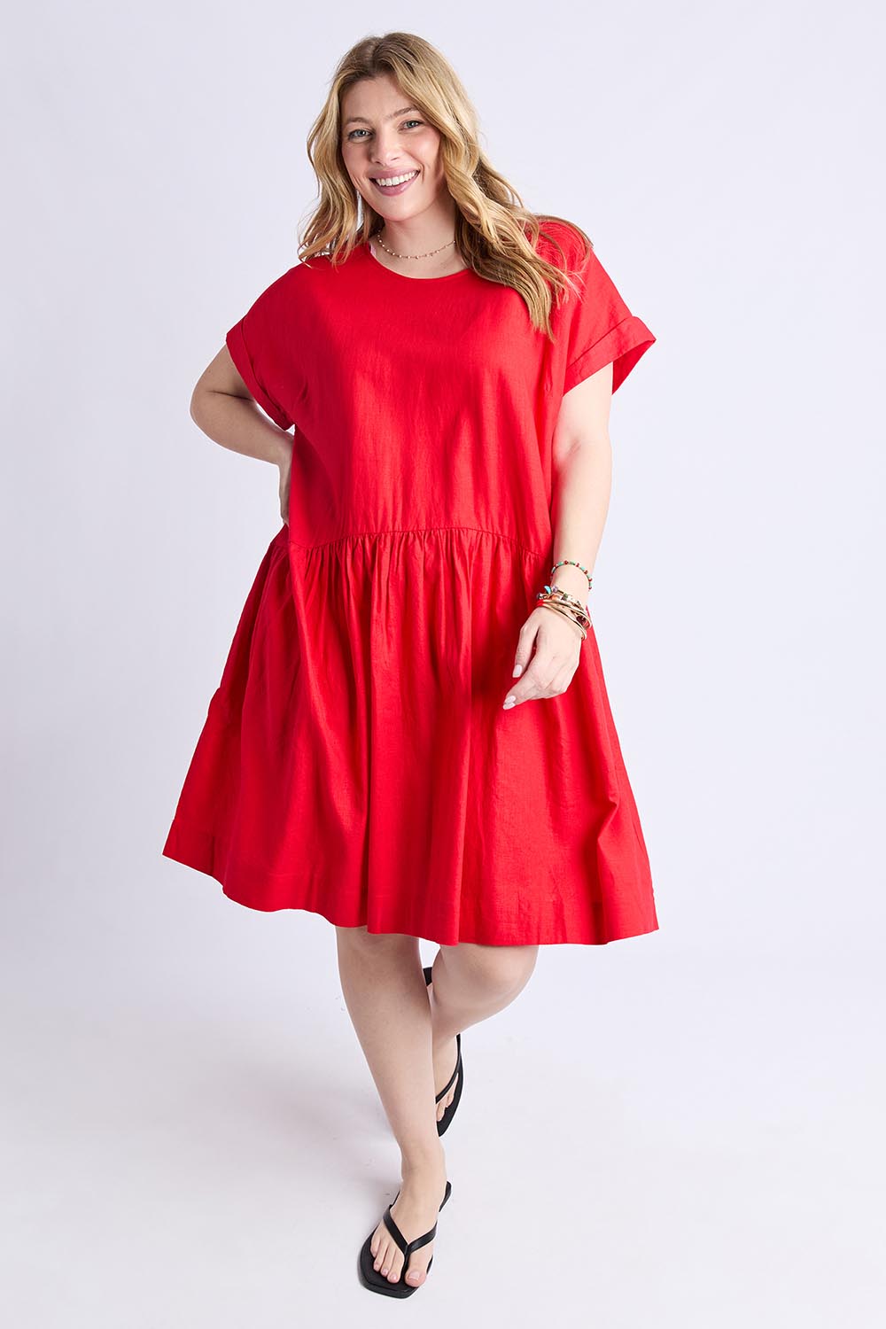 A model wearing the Sunset Hour Linen Blend Dress in colour Poppy (Red), from the front, showing the whole outfit