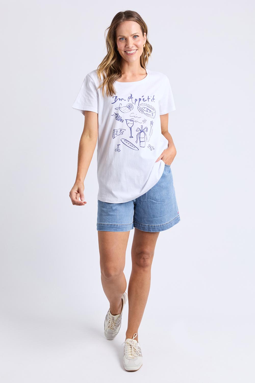 A model wearing the Bon Appetit Cotton Tee in colour White (White), from the front, showing the whole outfit