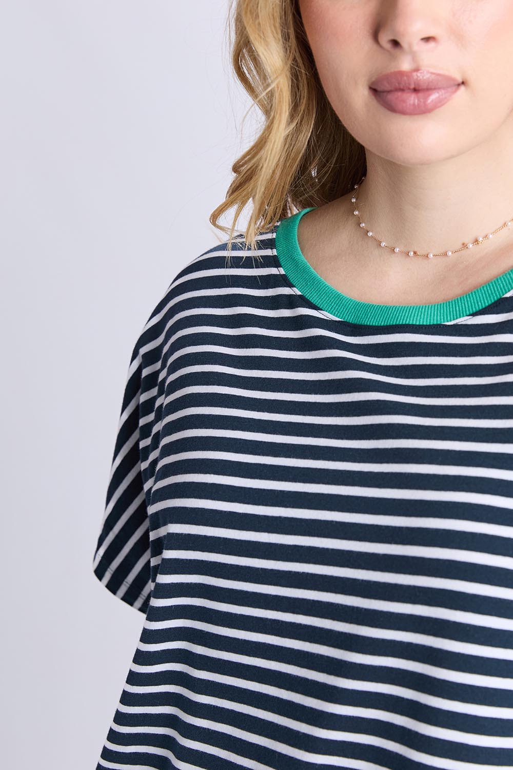 A model wearing the Sabrina Cotton Dress in colour Navywhite, from the front, cropped image