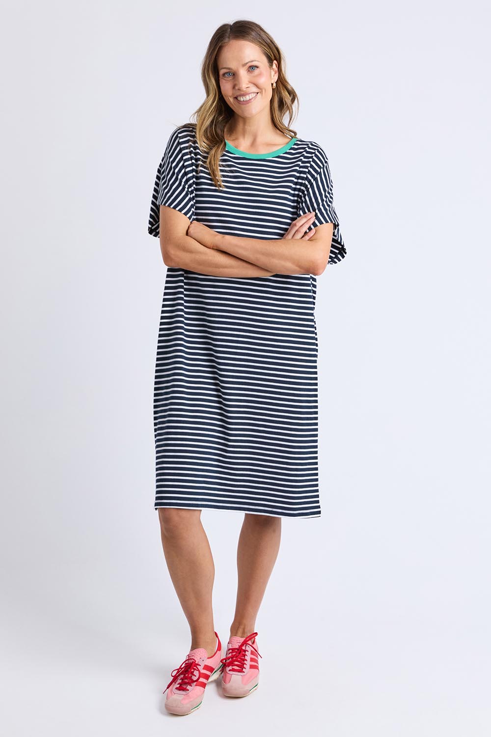 A model wearing the Sabrina Cotton Dress in colour Navywhite, from the front, showing the whole outfit