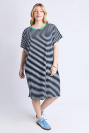 A model wearing the Sabrina Cotton Dress in colour Navywhite, from the front, showing the whole outfit