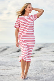 Model Bianca wearing size 10 of the Bon Bon Cotton Dress in colour Redpink, from the front, showing the whole outfit