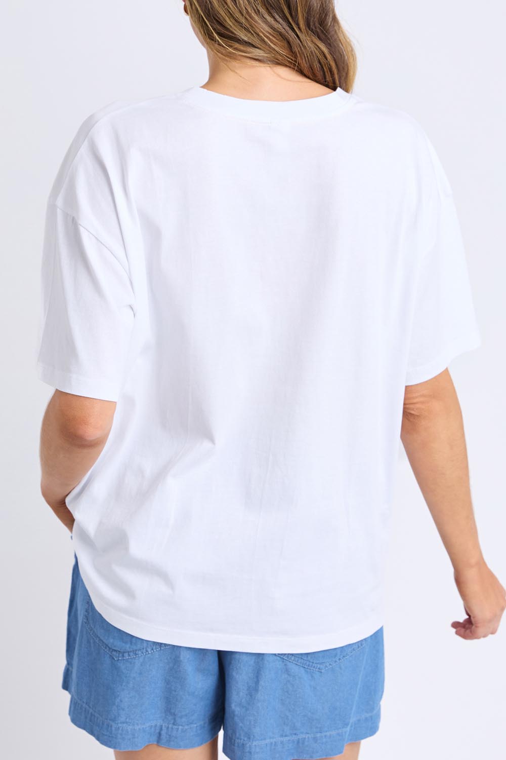 A model wearing the Limone Fresco Cotton Tee in colour White (White), from the back