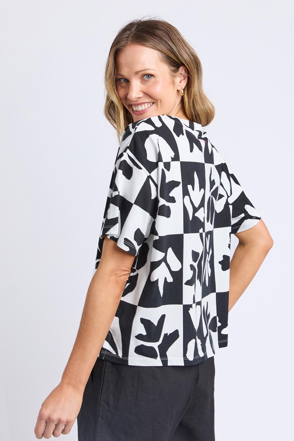 A model wearing the Splice Cotton Tee in colour Blackwhite, from the back