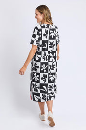 A model wearing the Splice Cotton Dress in colour Blackwhite, from the back
