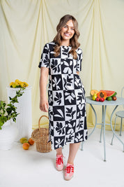 A model wearing the Splice Cotton Dress in colour Blackwhite, from the front, showing the whole outfit