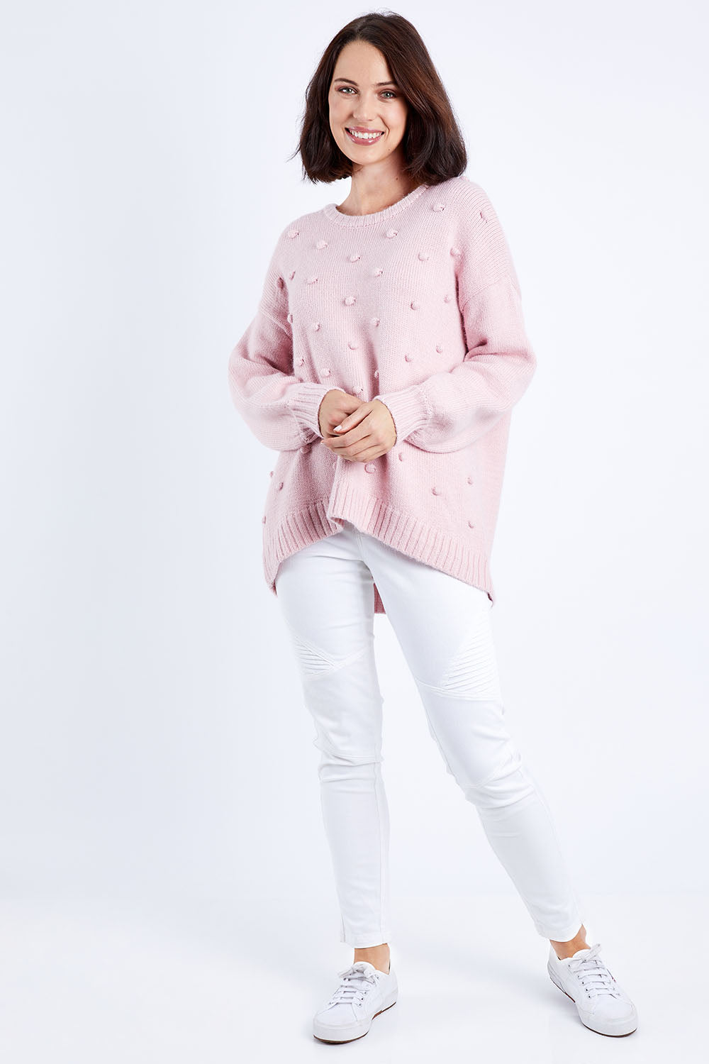 Model Andrea wearing size 10 of the Spot The Difference Knit in colour Dpink (Pink), from the front, showing the whole outfit