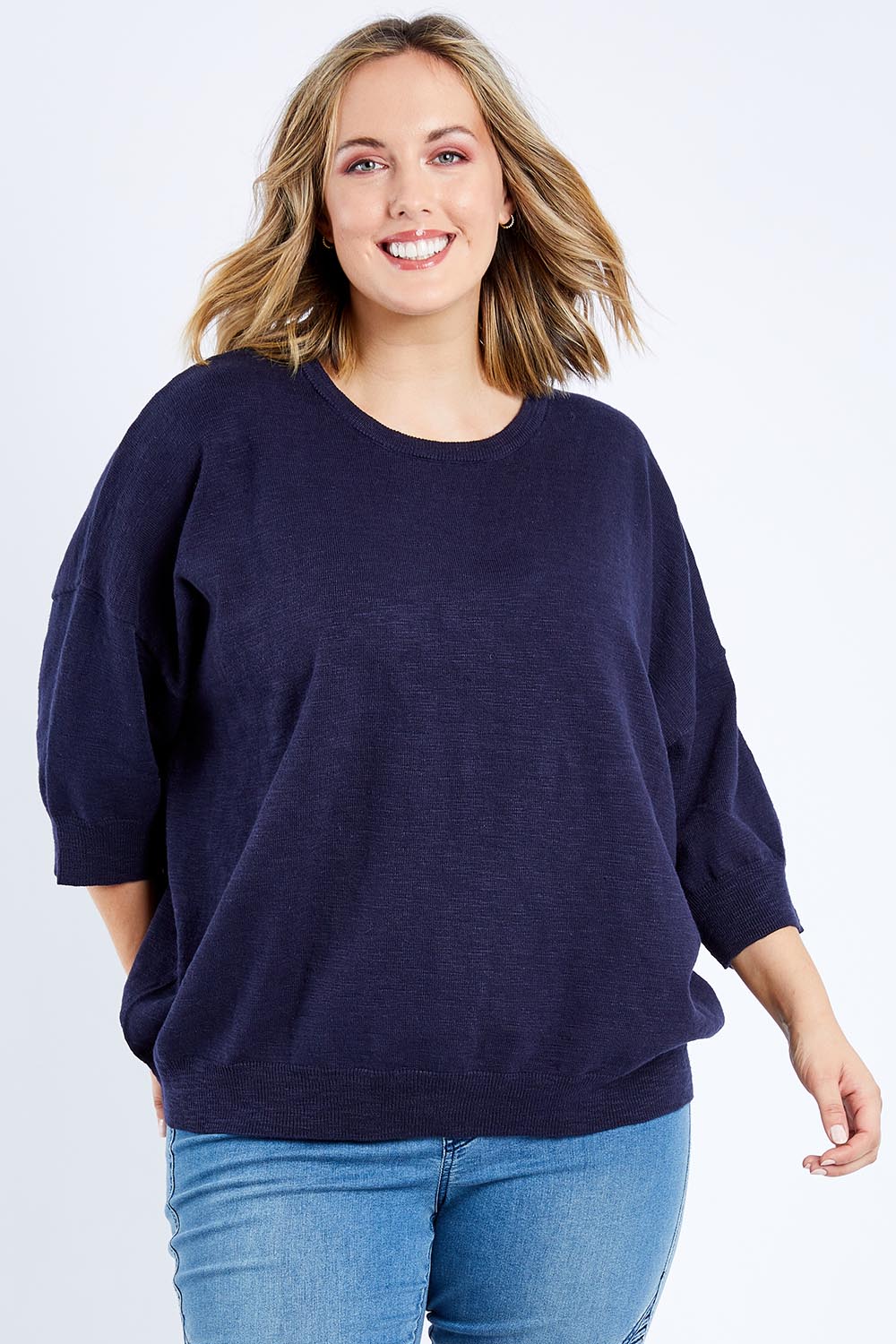 Model Jess wearing size 14 of the Elsie Knit in colour Dsapphire (Blue), from the front, cropped image