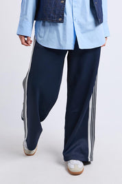 A model wearing the York Pants in colour Navy (Blue), from the front, cropped image