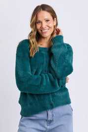 A model wearing the Paris Cardigan in colour Teal (Green), from the front, cropped image