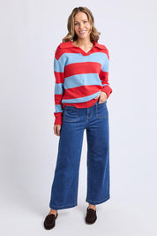A model wearing the Striped Cotton Polo Knit in colour Brightred, from the front, showing the whole outfit