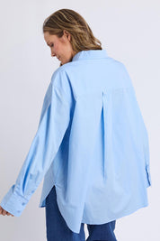 A model wearing the Sky Shirt in colour Lightblue (Blue), from the back