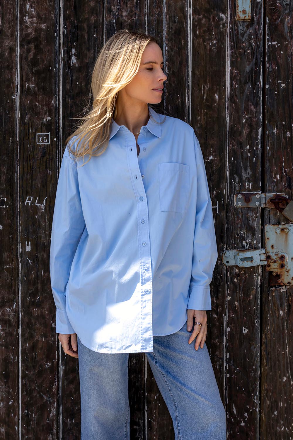 A model wearing the Sky Shirt in colour Lightblue (Blue), from the front, showing the whole outfit