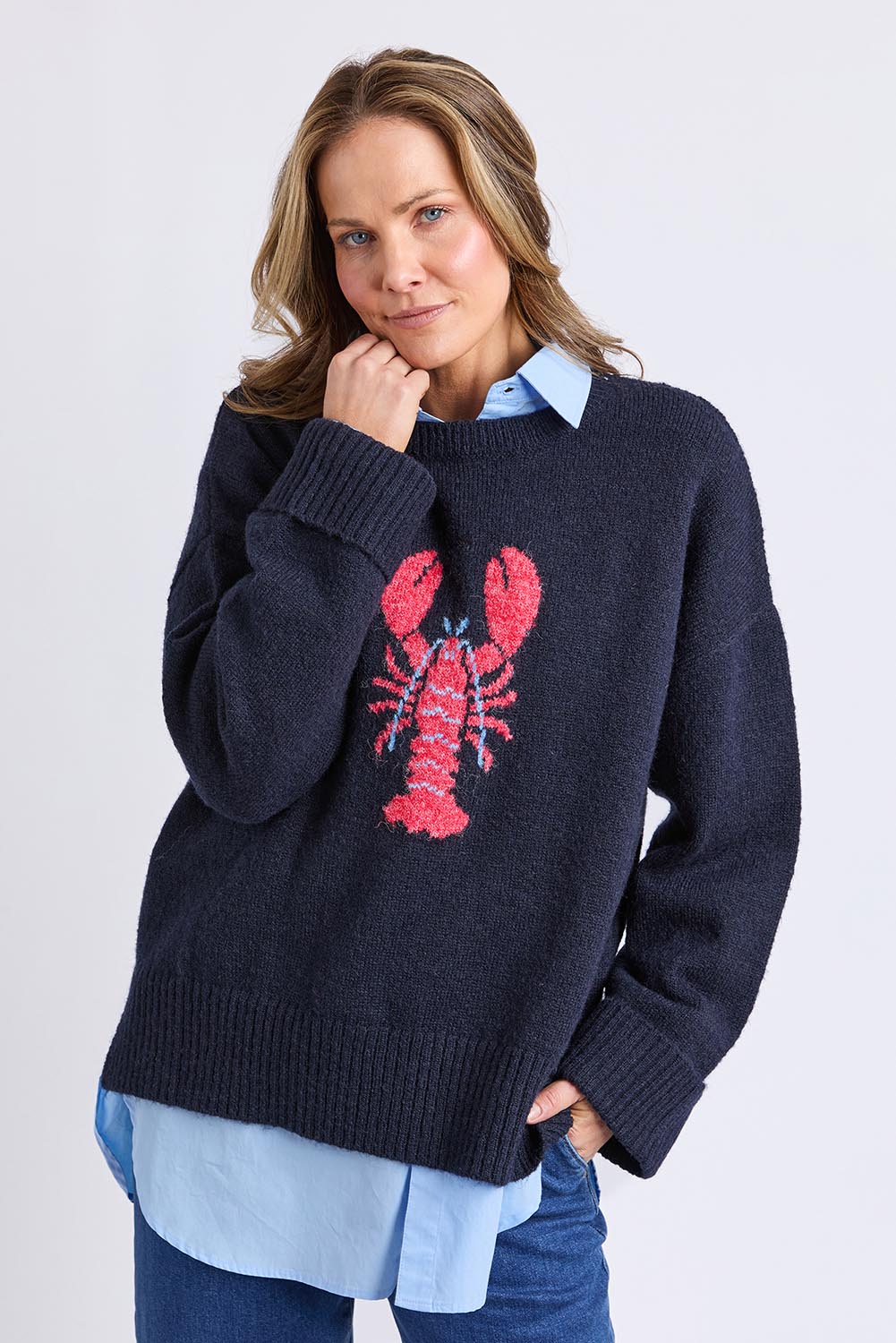 A model wearing the Lobster Intersaid Knit in colour Navy (Blue), from the front, cropped image