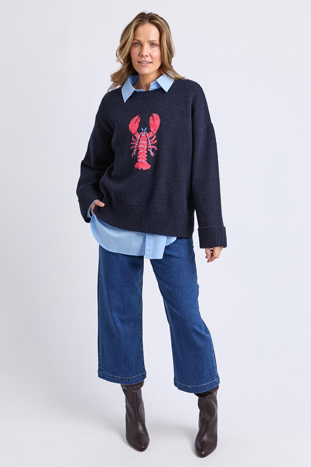 A model wearing the Lobster Intersaid Knit in colour Navy (Blue), from the front, showing the whole outfit