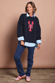 Model Riina wearing size S of the Lobster Intersaid Knit in colour Navy (Blue), from the front, showing the whole outfit