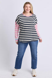 A model wearing the Gaeb Stripe Cotton Long Sleeve Tee in colour Whitenavy, from the front, showing the whole outfit