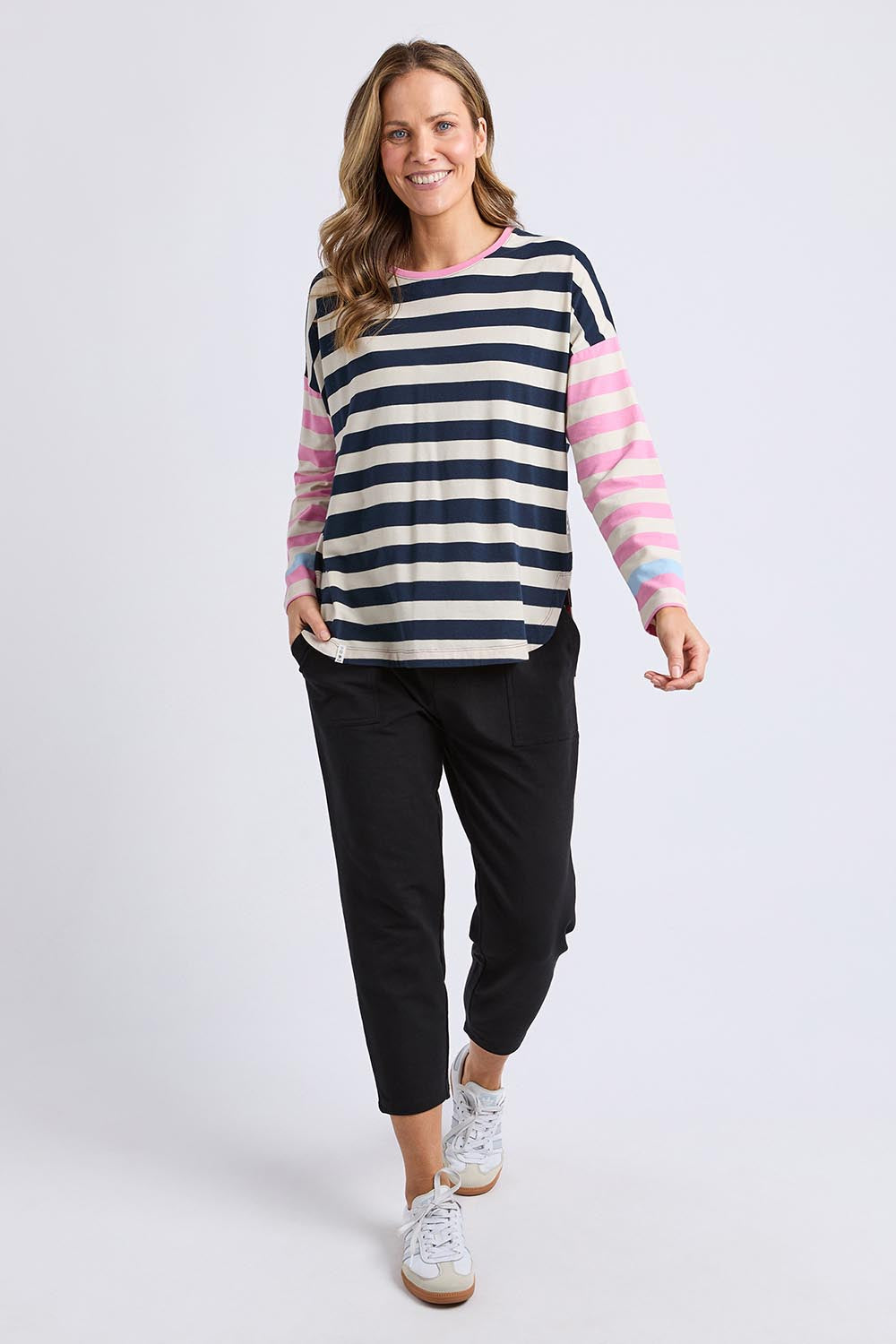 A model wearing the Gaeb Stripe Cotton Long Sleeve Tee in colour Whitenavy, from the front, showing the whole outfit