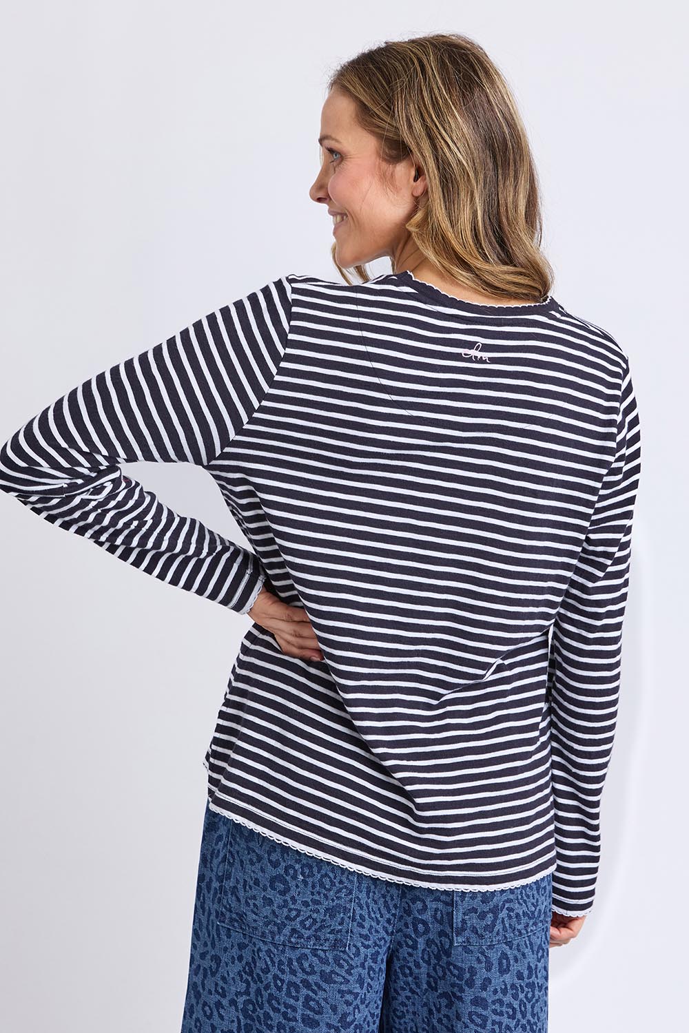 A model wearing the Drea Cotton Long Sleeve Tee in colour Navywhite, from the back